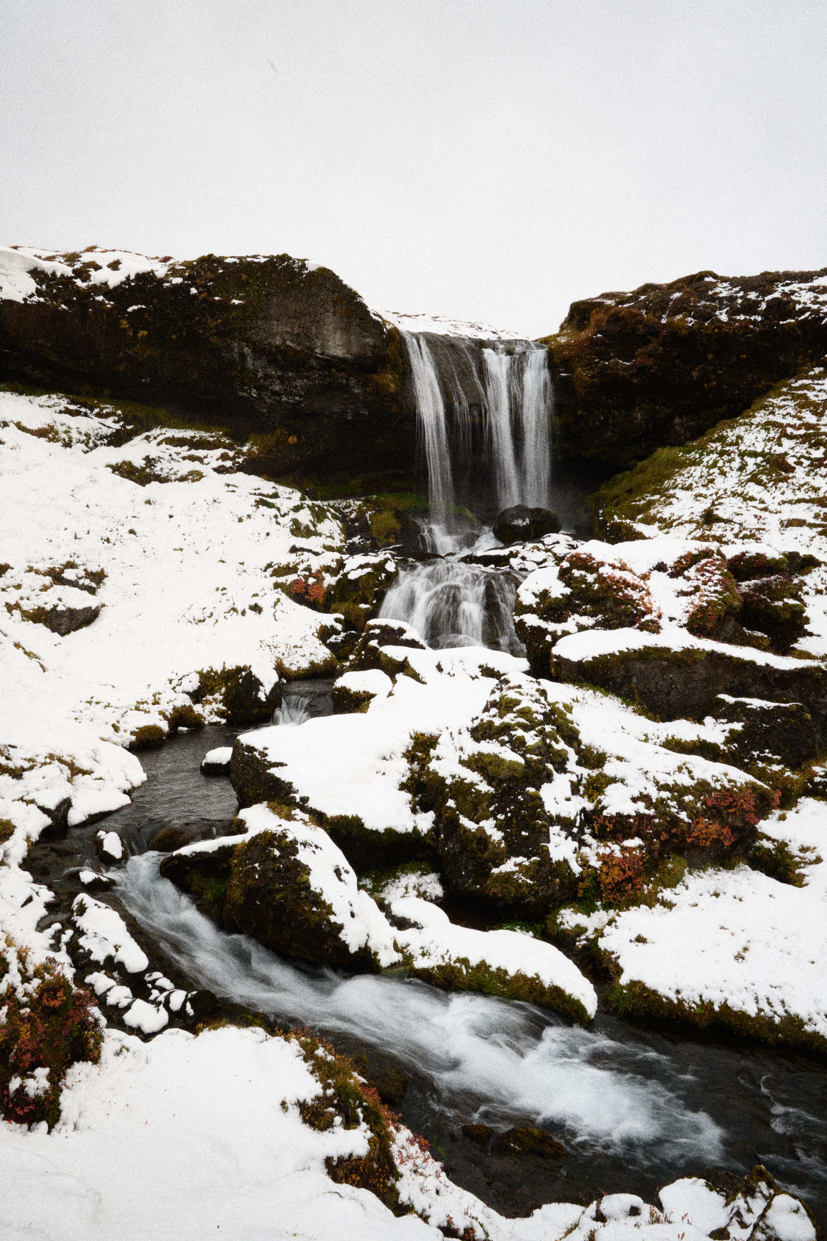 The same waterfall, snowed in and blown about by wind